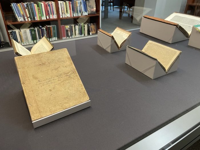 New Exhibit in the Seth Kasten Memorial Exhibit Case (Fall 2021) -- visible are several open books and a yellowed manuscript page with the text illegible